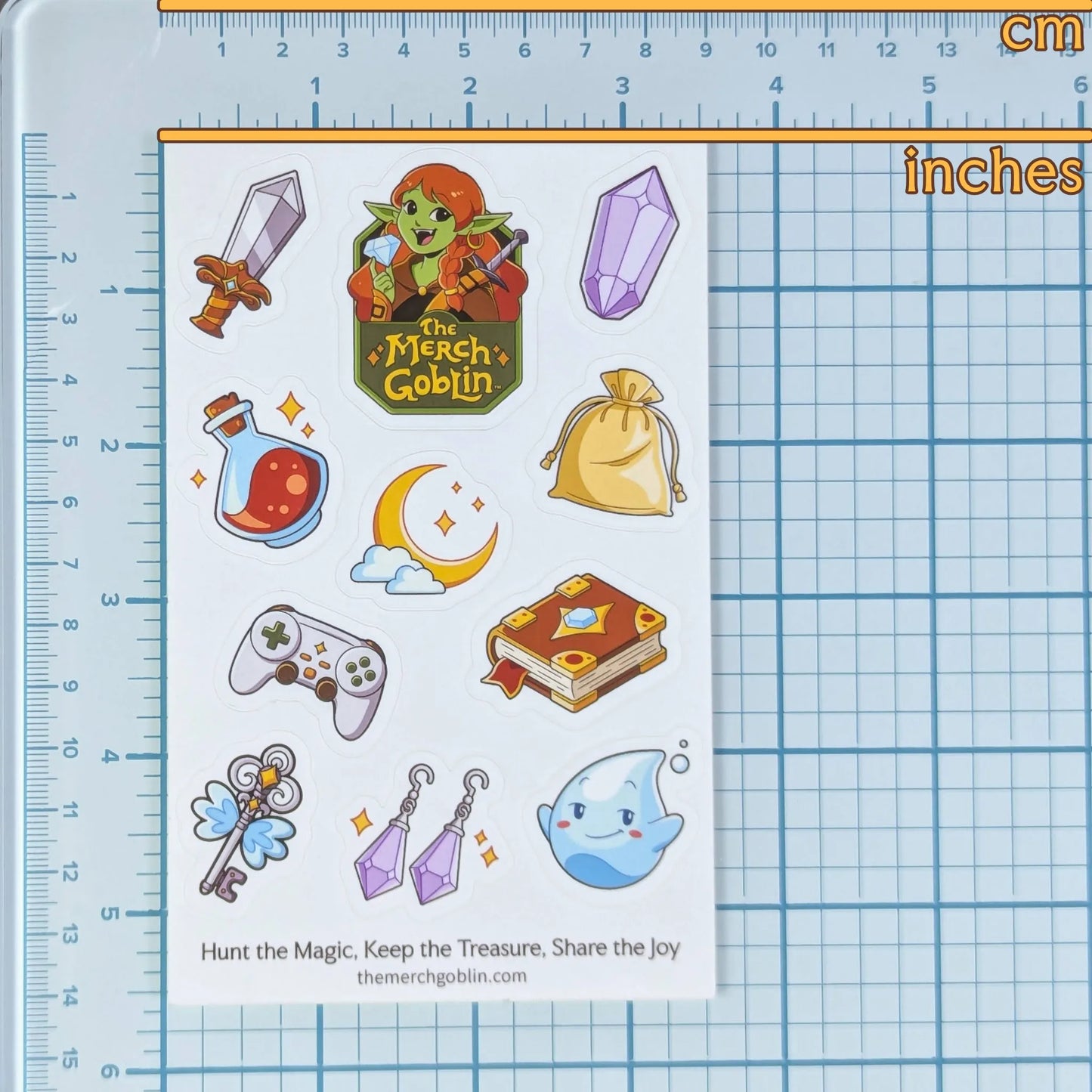 Sheet of stickers with 'Merch Goblin' branding on a ruler grid background to show measurements.