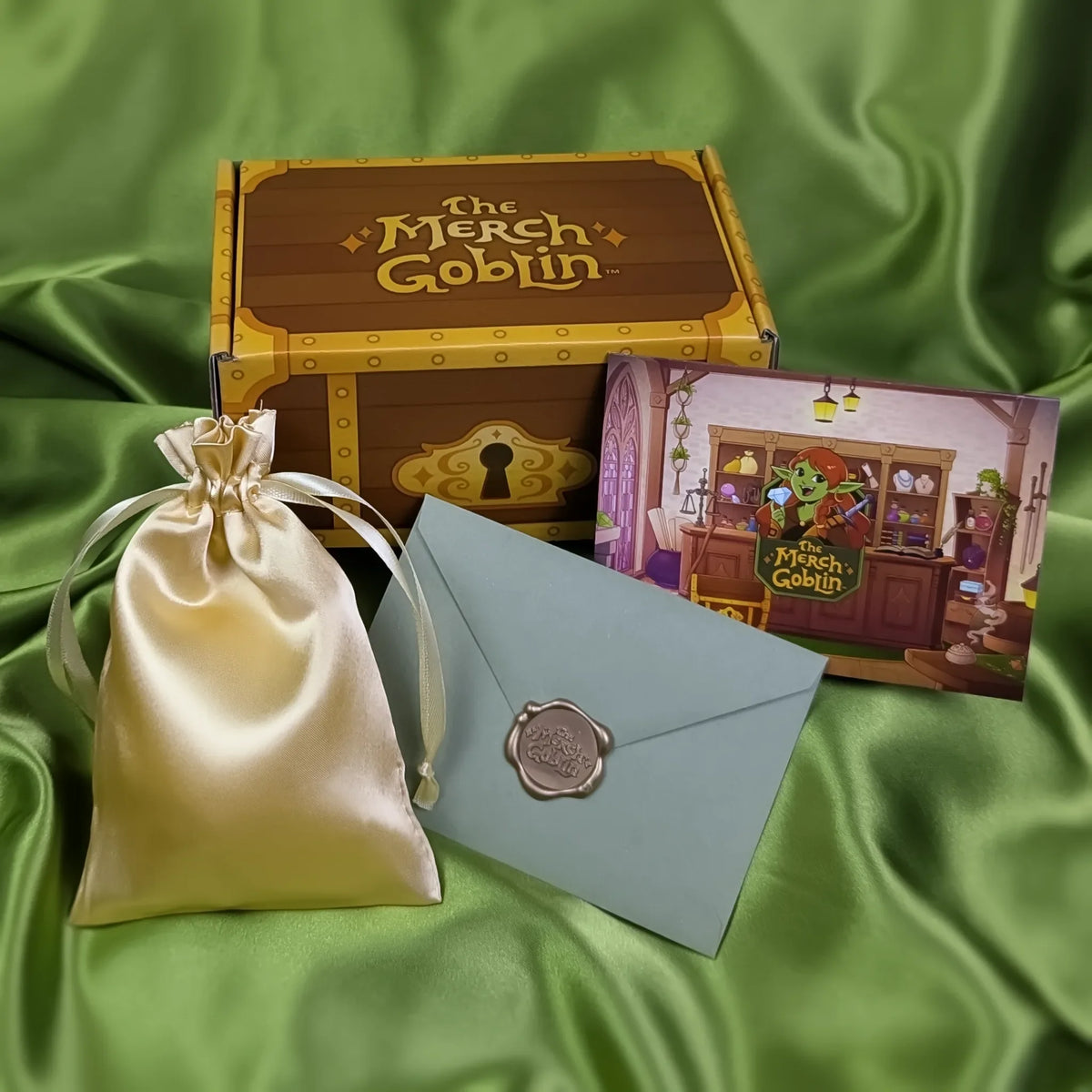 Treasure chest themed gift box with gold satin pouch, card, and envelope with gold seal