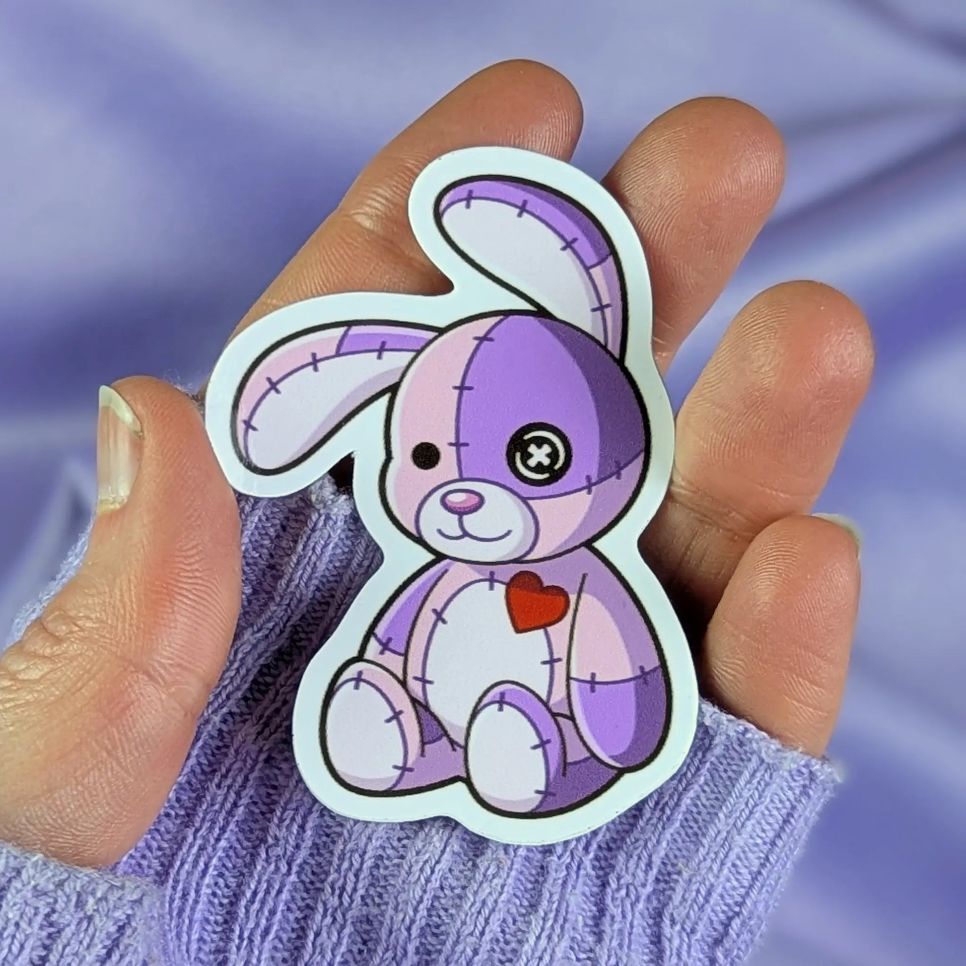 purple patchwork bunny sticker held in a hand