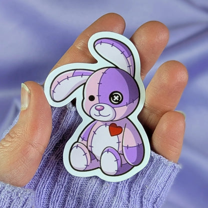 purple patchwork bunny sticker held in a hand