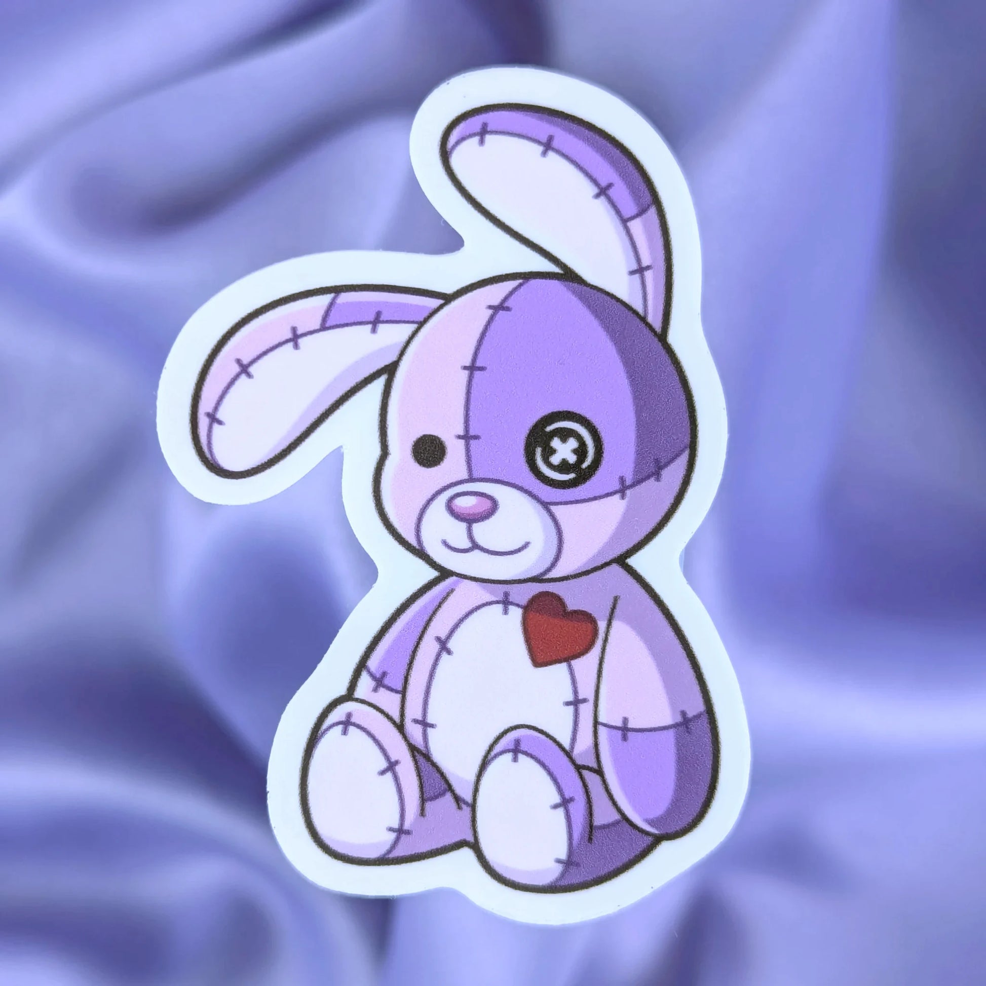 purple patchwork bunny sticker with a purple silk background
