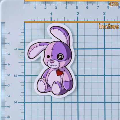 purple patchwork bunny sticker overlayed on top of a ruler grid
