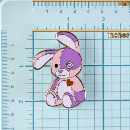 Cute pink & purple patchwork bunny pin on a grid background to show measurements.