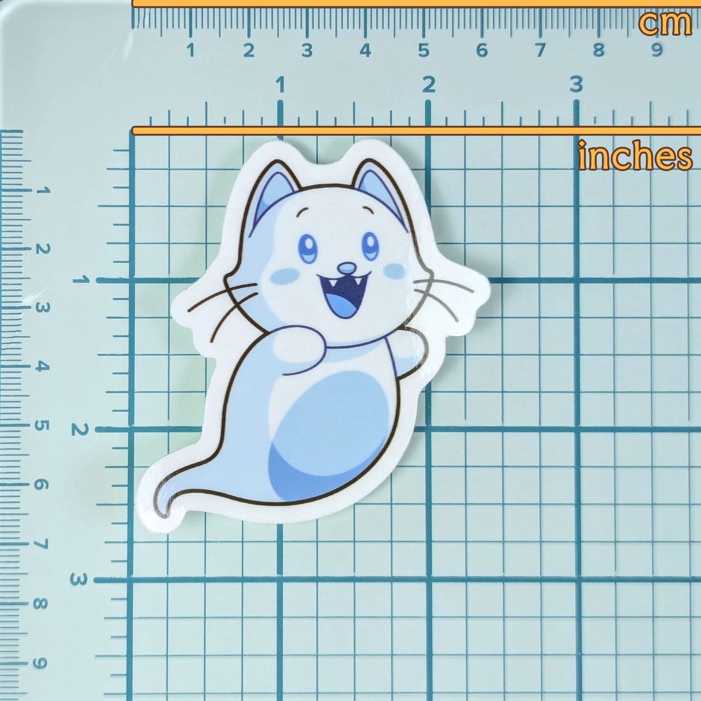 Cute ghost cat sticker on a grid background with measurements to show scale.