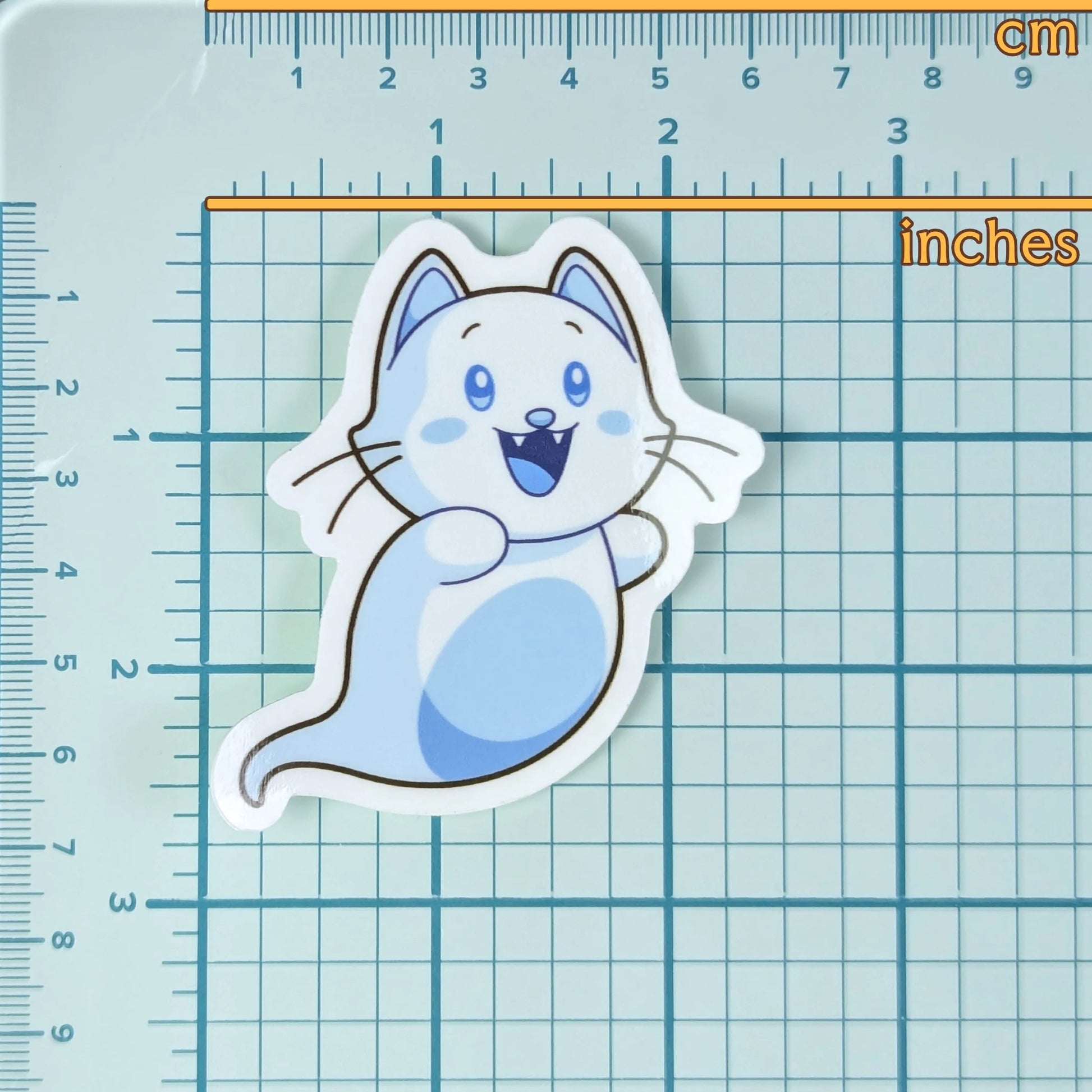 Cute ghost cat sticker on a grid background with measurements to show scale.