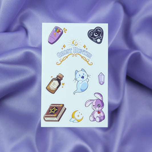 Sheet of ghost hunter themed stickers including an EMF ghost detector, spirit board planchette, Ghost Hunter sticker, sanity potion bottle, ghost cat, purple gem, spooky book, moon, and cursed stitched bunny