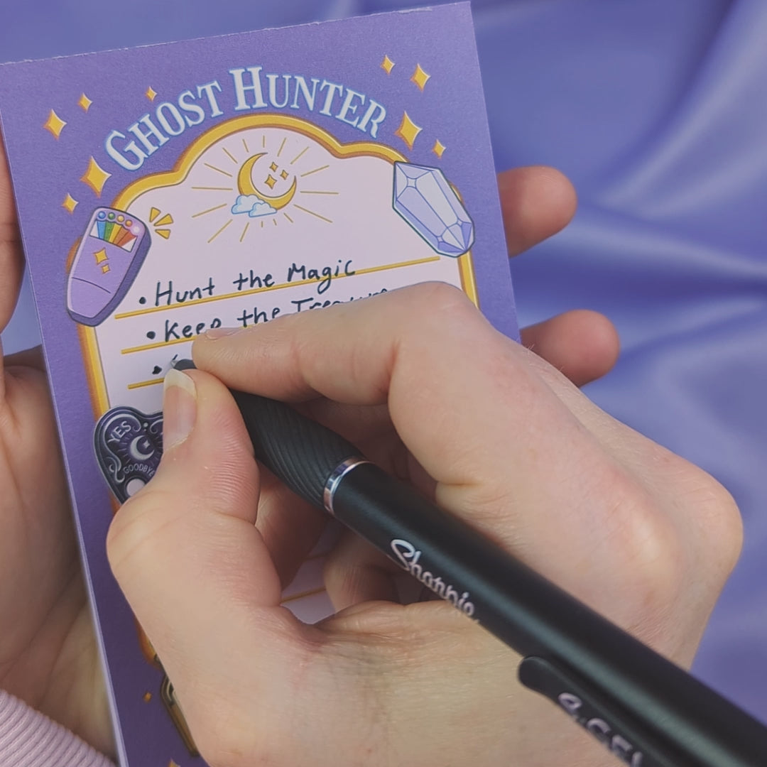 Video of a ghost hunter themed notepad with a hand writing on it to showcase that the ink doesn't bleed through