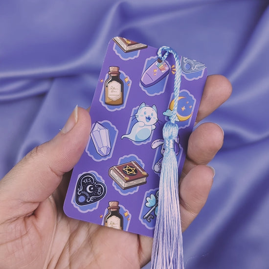 Video of a purple ghost hunter themed bookmark that shows two different images on each side