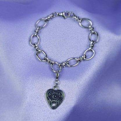 Stainless steel bracelet with detachable heart-shaped spirit board pendant