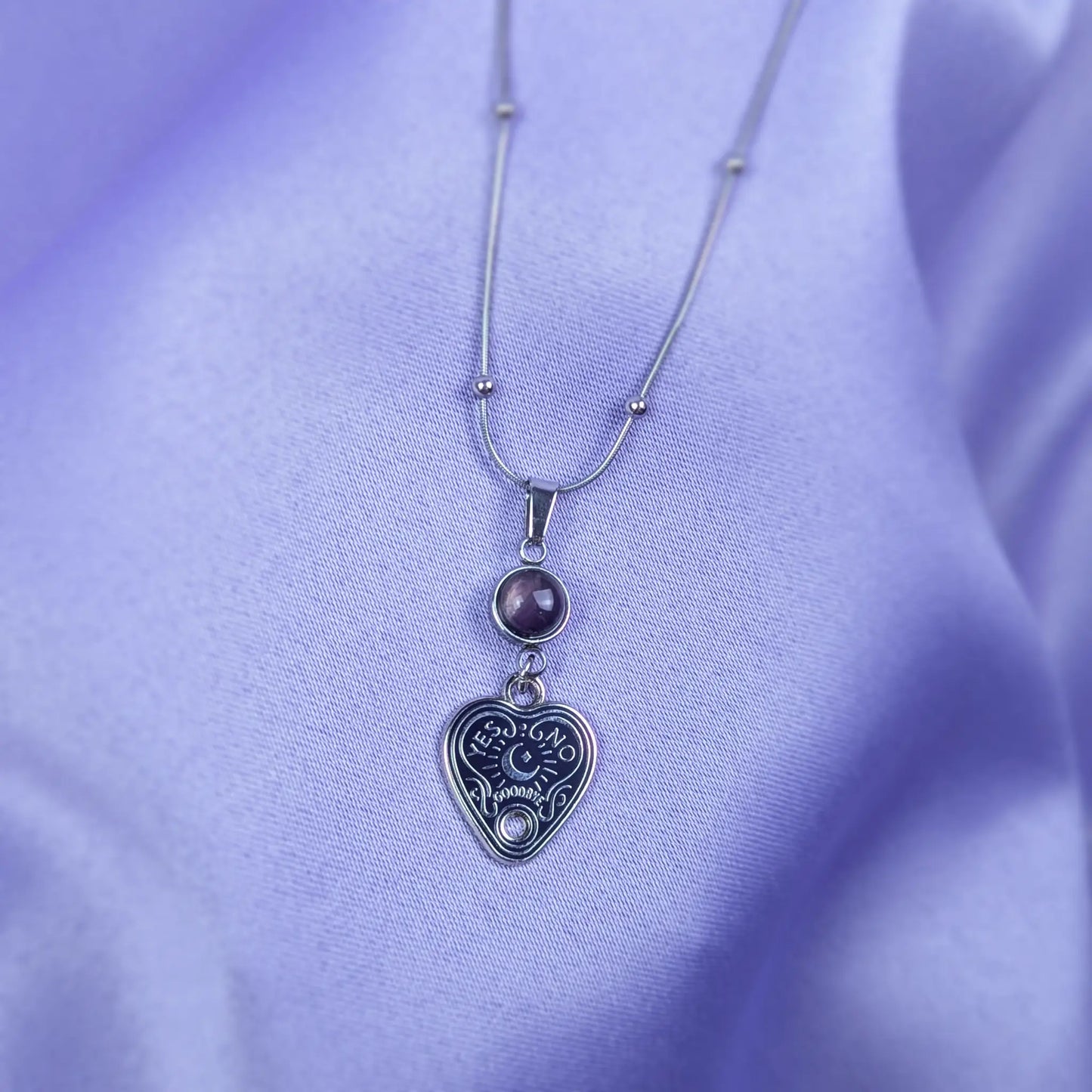 Stainless steel necklace with heart-shaped spirit board pendant and purple amethyst gemstone
