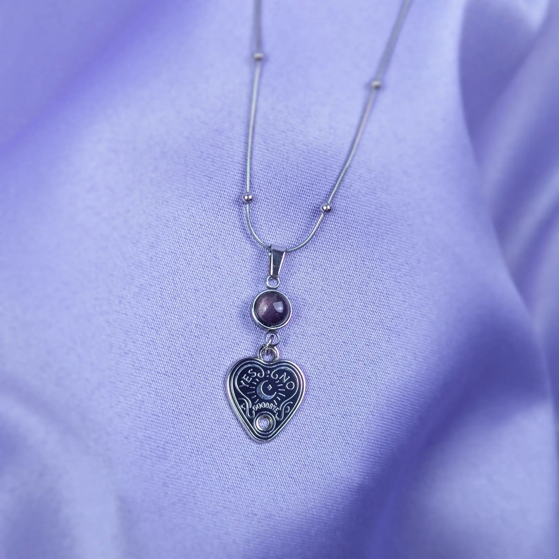 Stainless steel necklace with heart-shaped spirit board pendant and purple amethyst gemstone